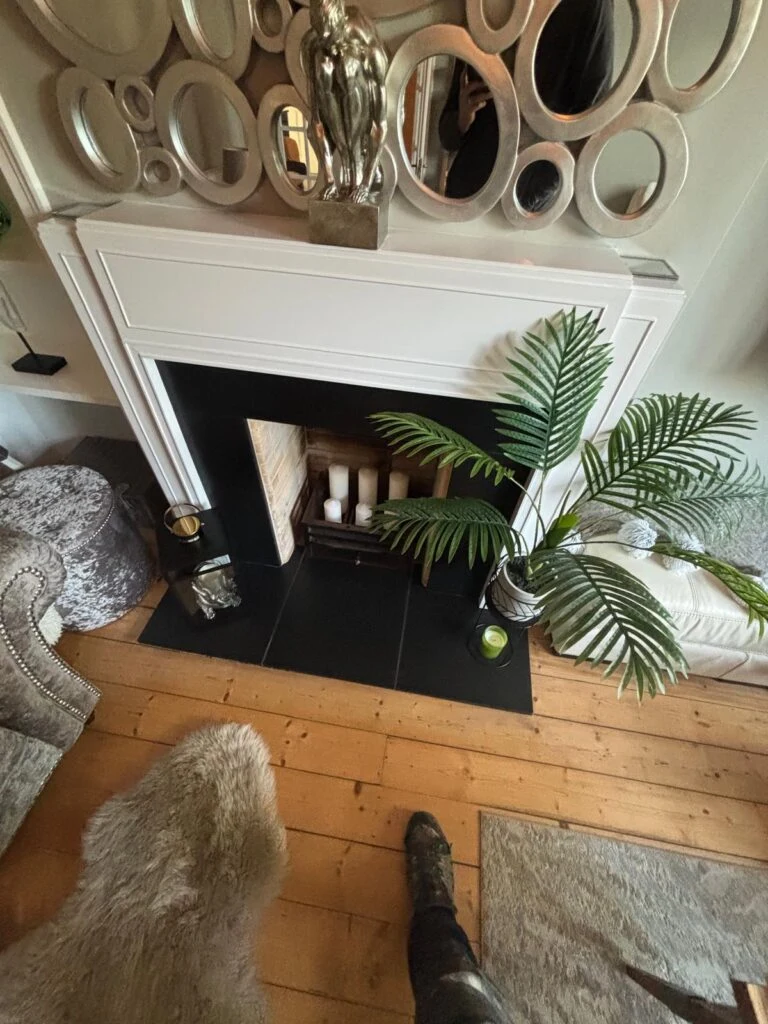 Stove within a white mantel in a furnished room