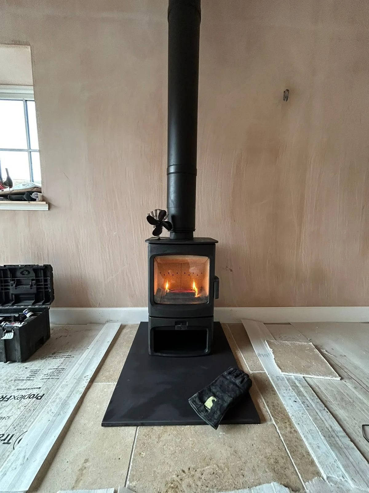 Freestanding stove with a black flue and rectangular hearth